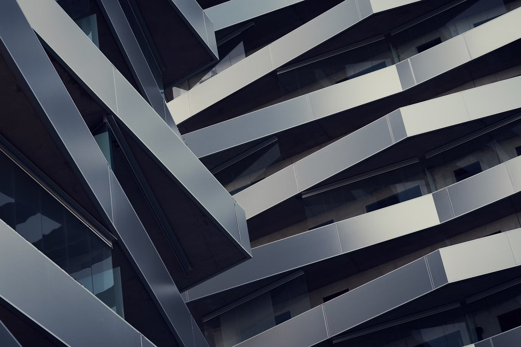 Abstract view of a building facade with geometric, layered balconies