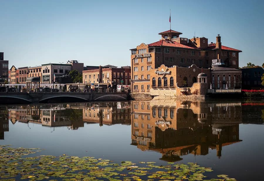 Hotel Baker in downtown St. Charles reflected in on the water beside the bridge