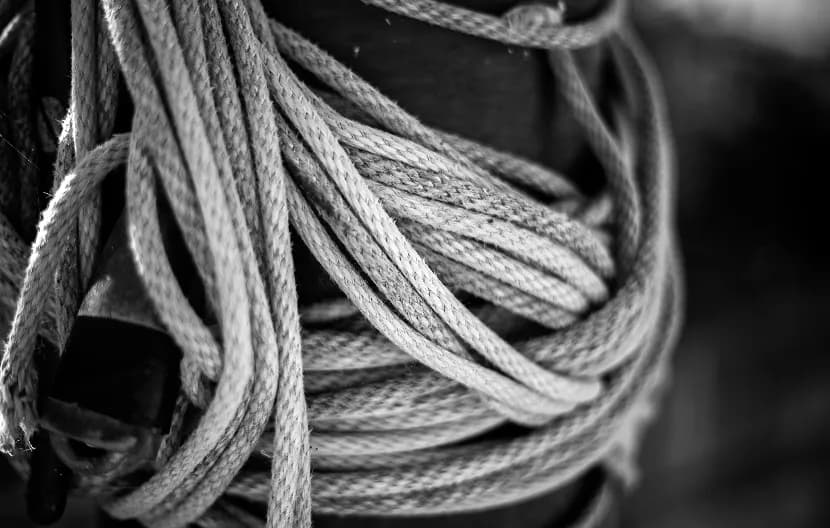 Coiled rope wrapped around a dark pole