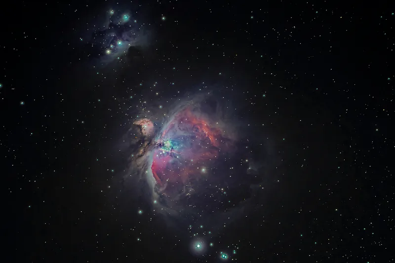 Colorful nebula in a star field, with bright pink, purple, and blue clouds