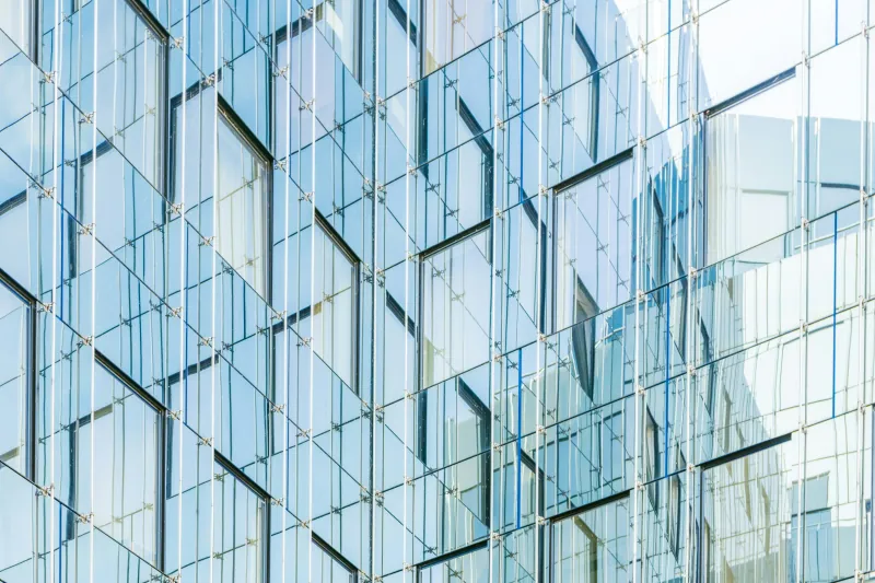 Glass office building facade with reflective windows