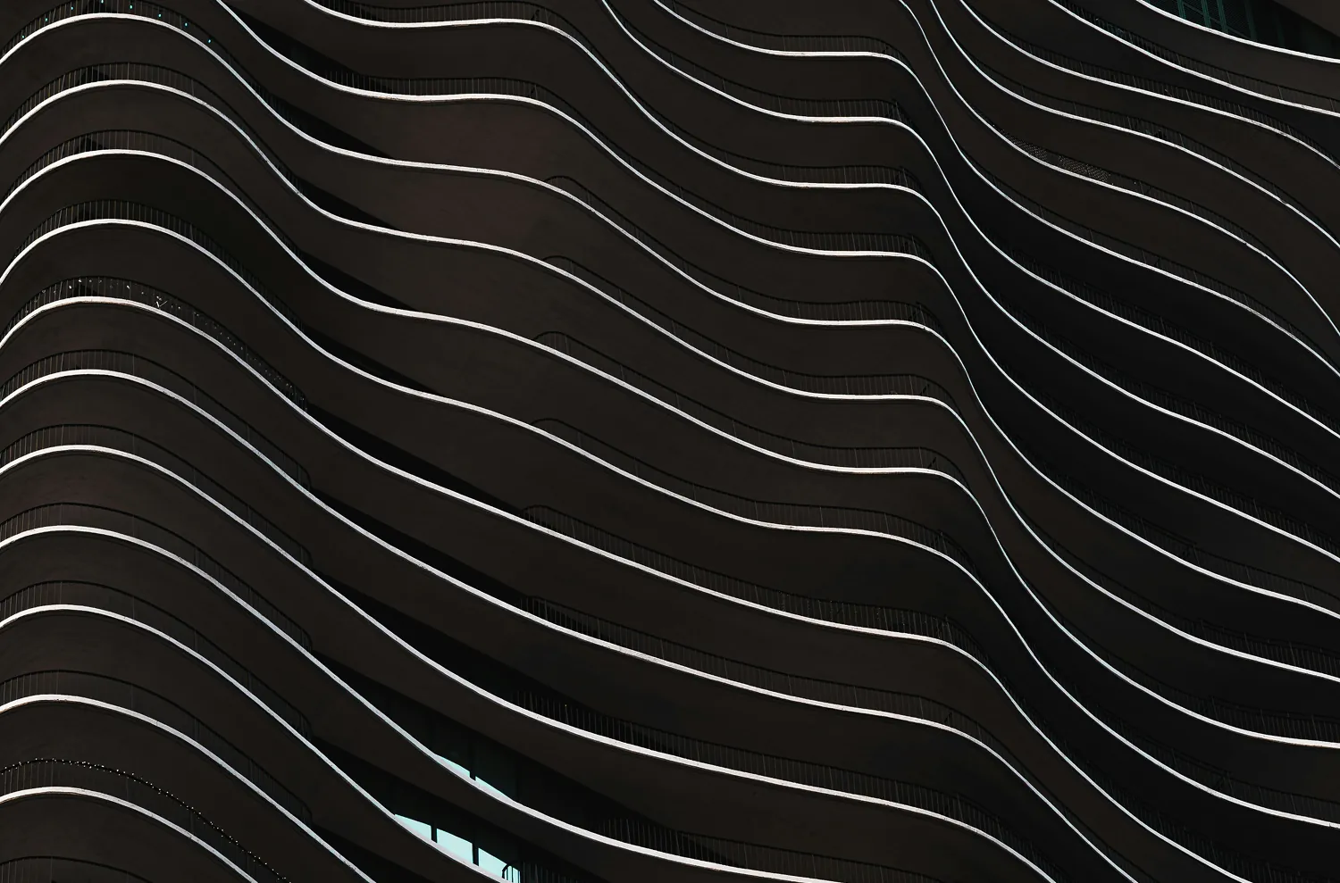 Abstract view of a building facade with wavy, layered balconies