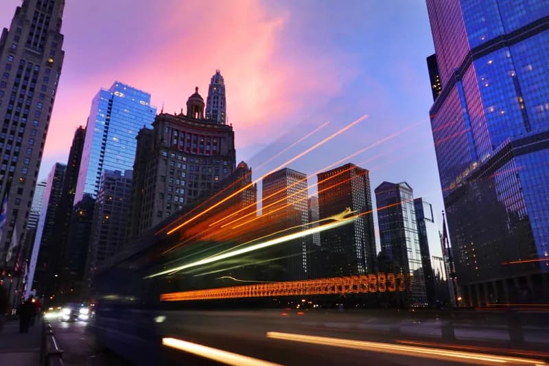 Chicago skyline at dusk with light trails from passing traffic