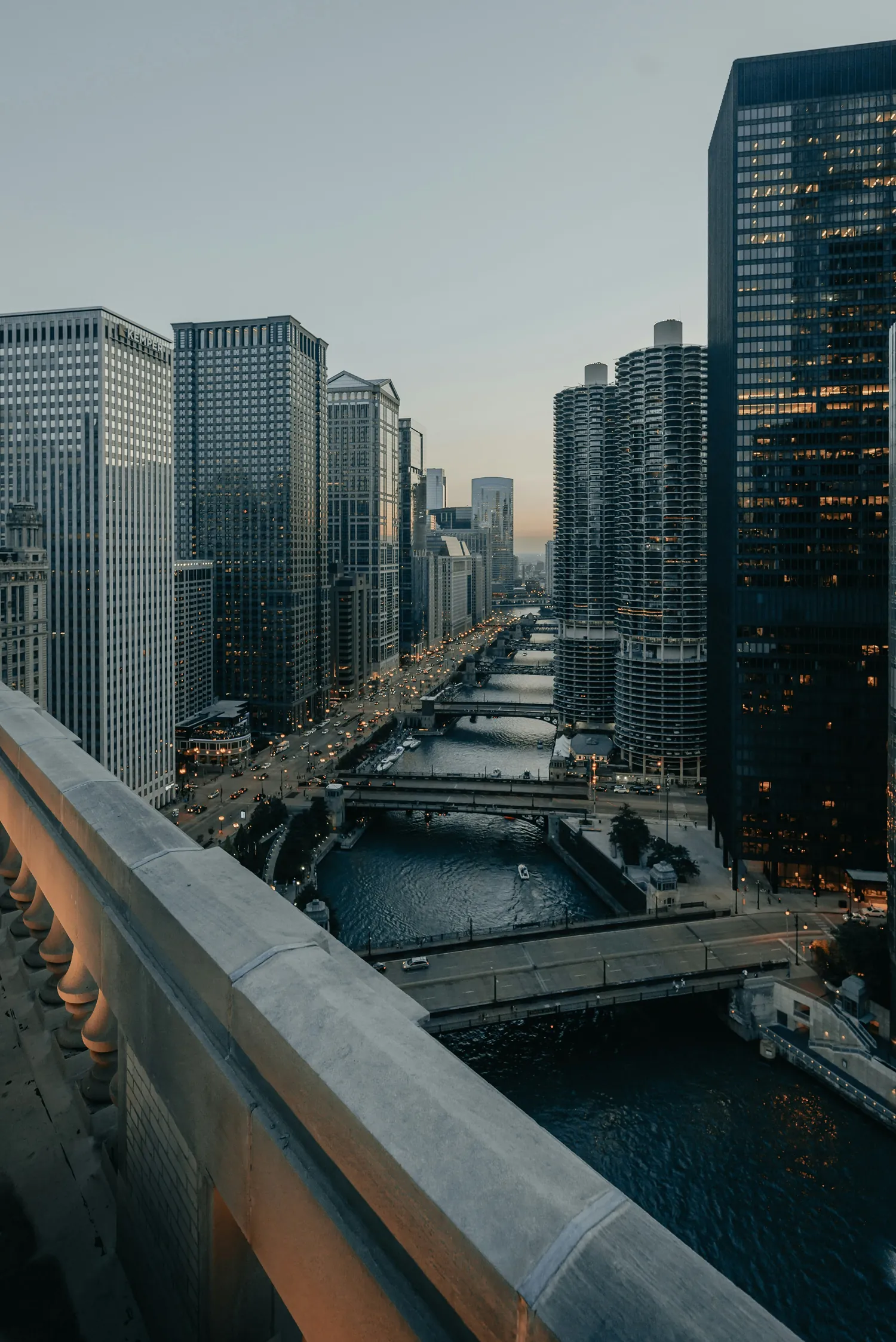 Chicago skyline at dusk with the river, bridges, and illuminated high-rise buildings