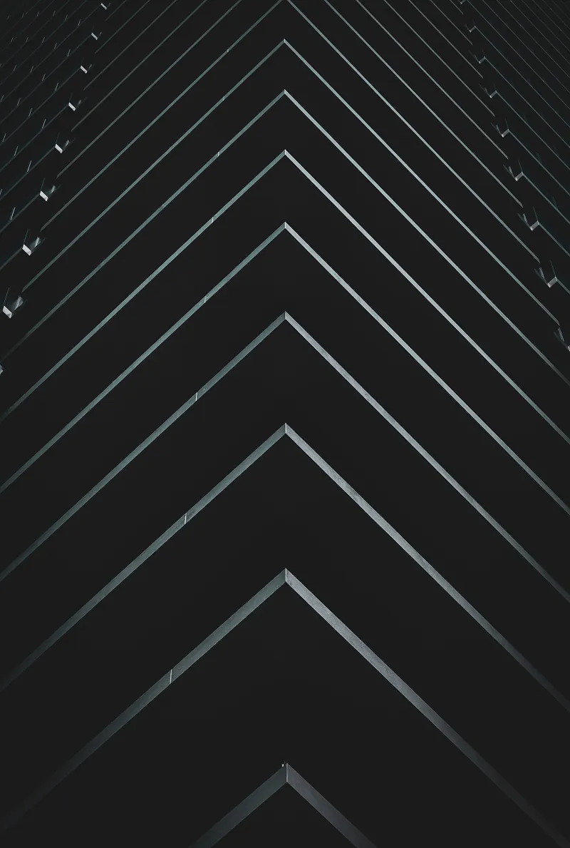 Abstract view of a building facade with geometric, layered balconies