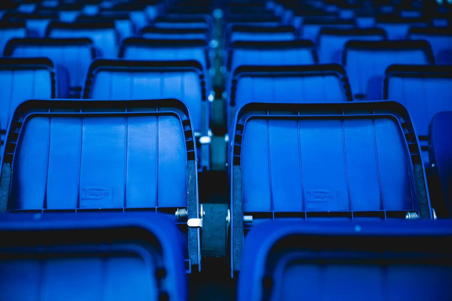 Rows of empty blue stadium seats